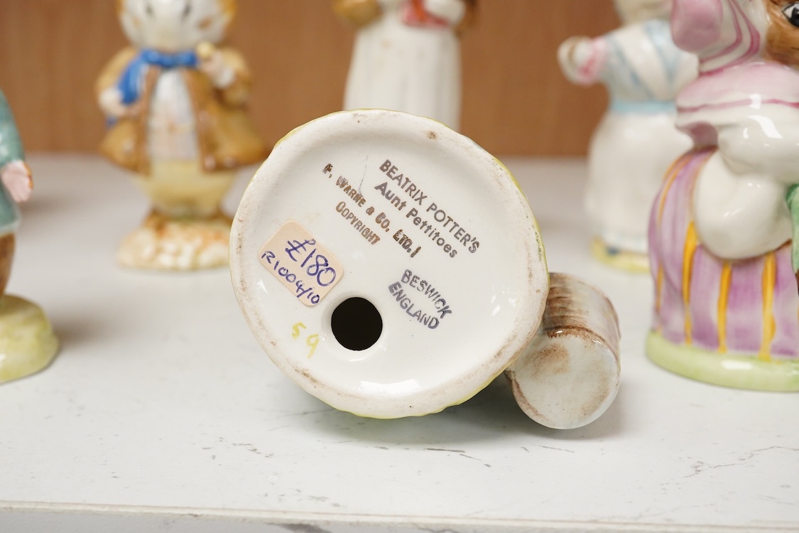 A collection of thirteen Beatrix Potter character figures, stamped with a gold stamp F Warn and Co Ltd, Beswick England, largest 12cm high